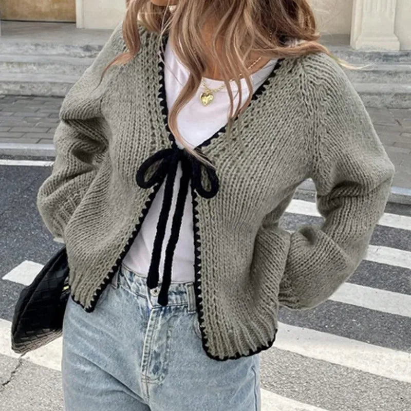 Lace-up front cardigan sweater with crocheted flower detail in solid colour
