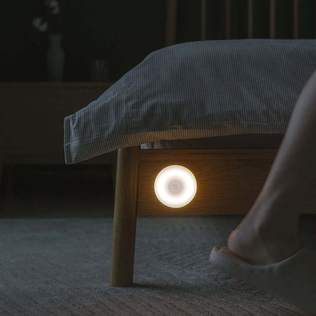 White modern Mijia Night Light 2 Bluetooth bedside lamp with human body induction on wooden table
