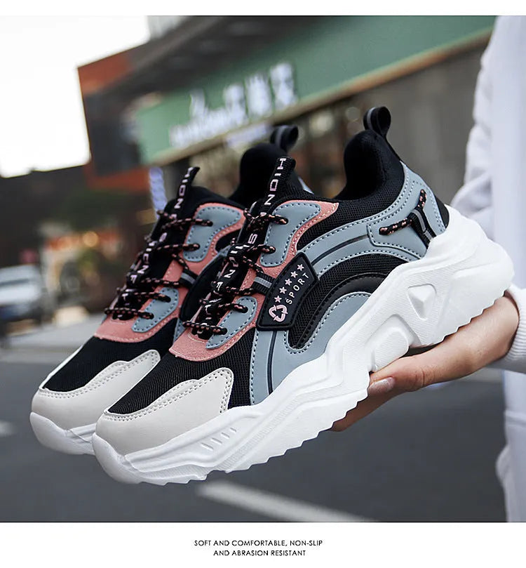 Women's white thick-soled casual sneakers with mesh upper, round toe, and buckle detail.