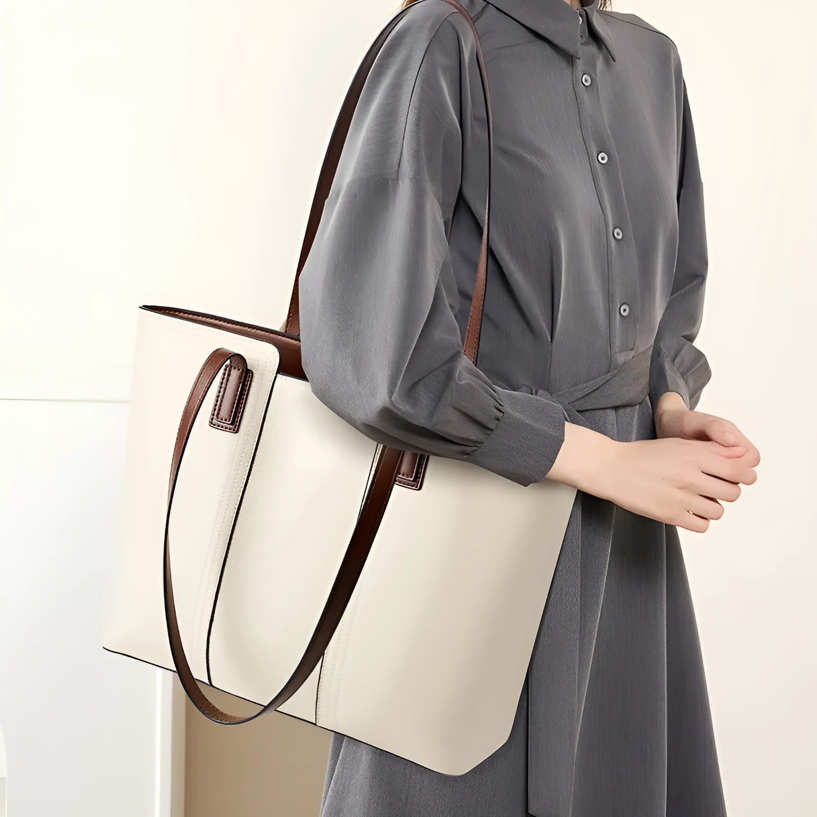 Black genuine leather women's shoulder bag showing internal organiser pockets and crossbody strap