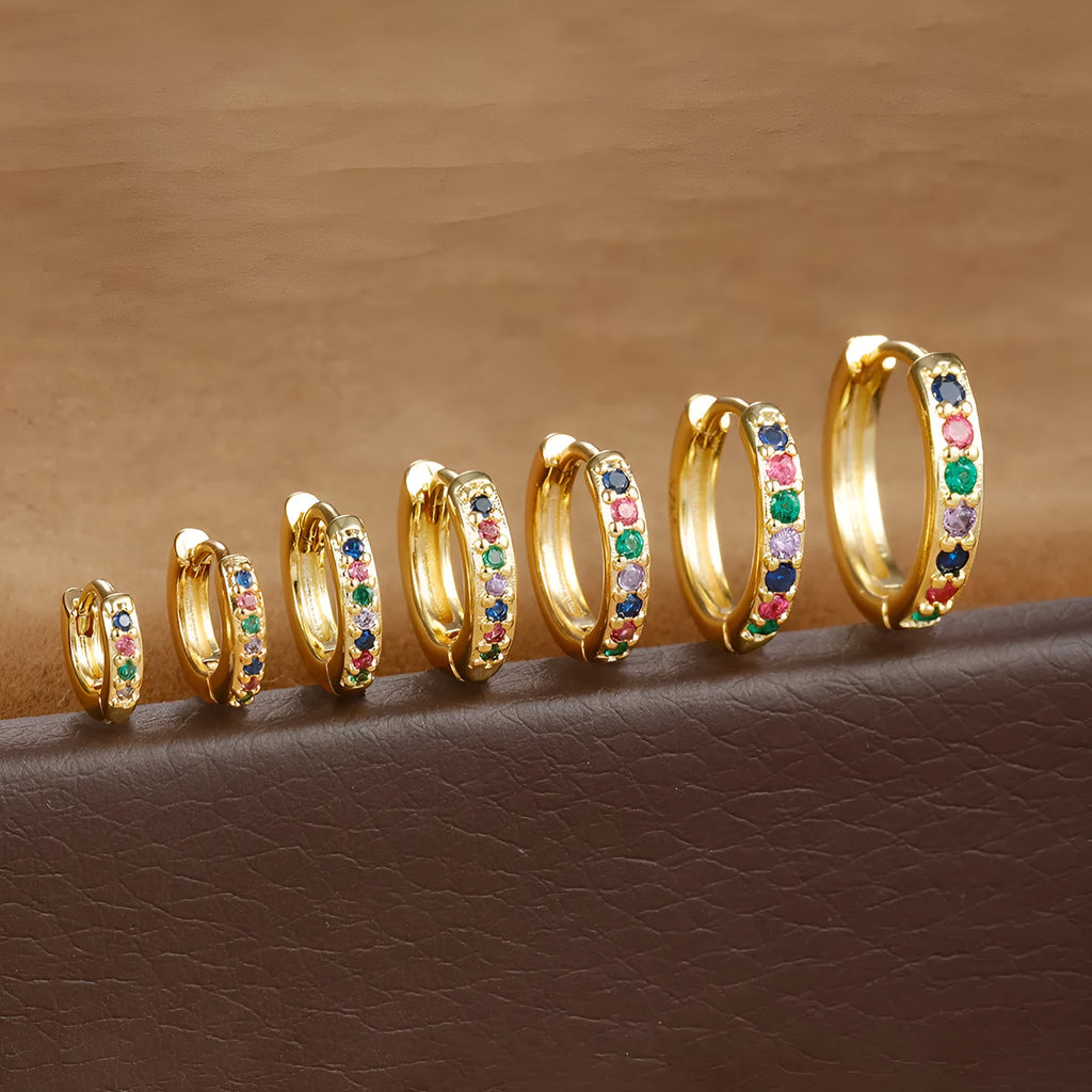 A pair of perforated circle stud earrings in a choice of gold, rose gold, or silver colour.
