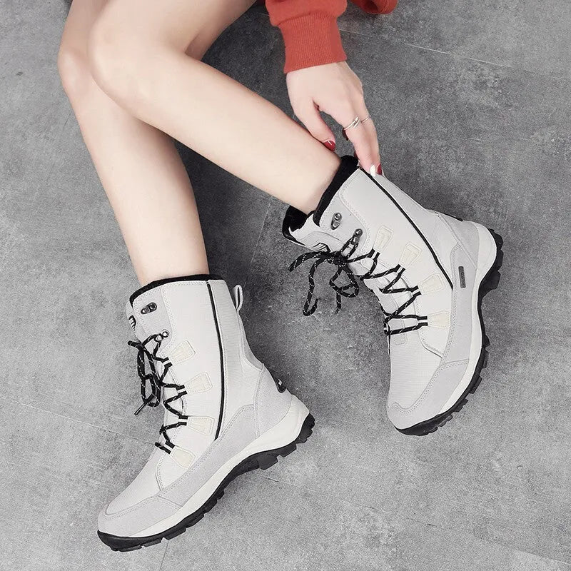 Black women's mid-calf leather snow boots with a round toe and thick rubber sole on a white background.