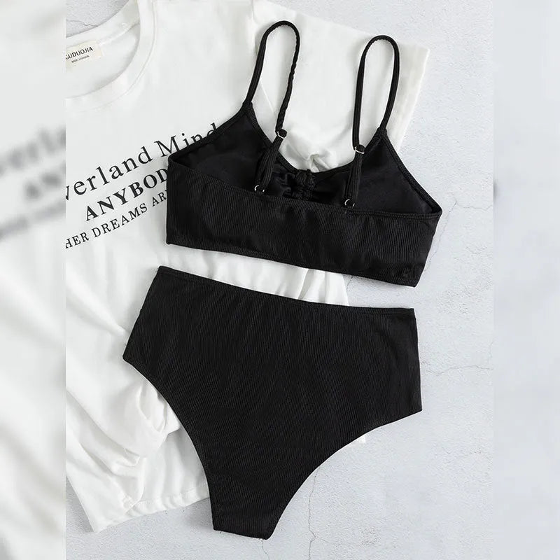 Black women's swimsuit set with sling bikini top and high-waist shorts with side splits