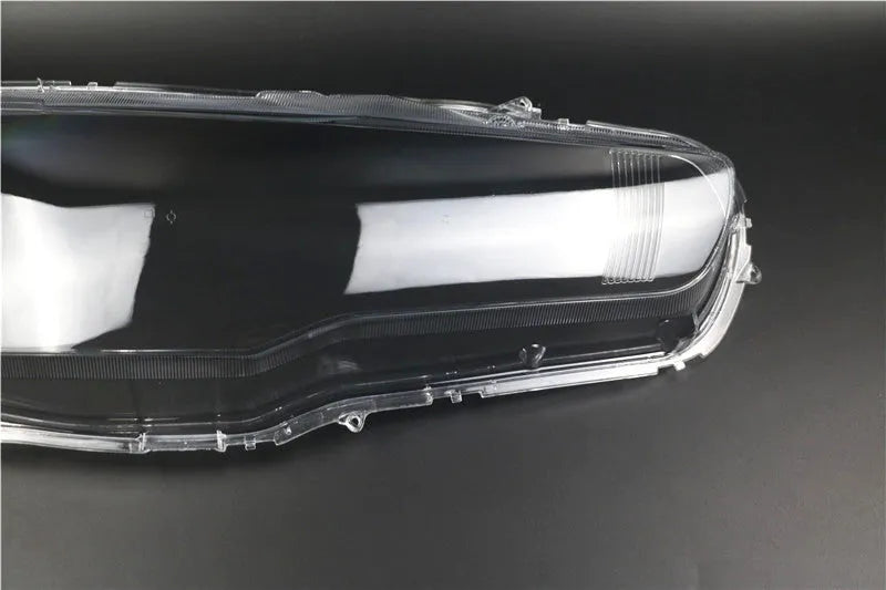 Transparent plastic headlight housing cover measuring 50mm by 30mm by 20mm