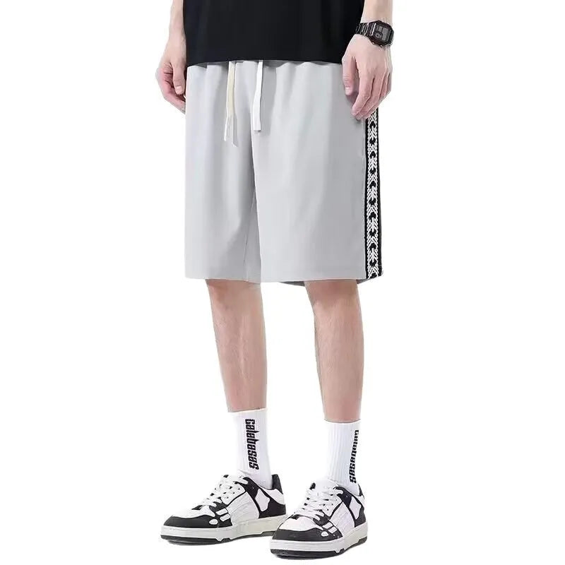 Men's black baggy track pants with loose fit and elastic waistband