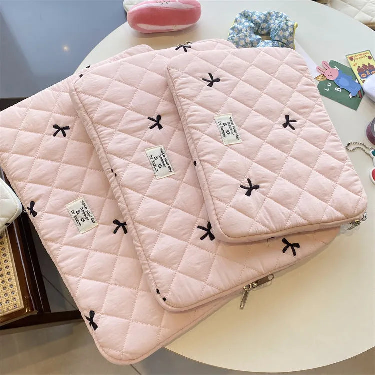 Nylon laptop storage bag with embroidered rhombus and bow design in light blue.