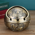 Alloy decorative ashtray with smoke extinguishing slot in bronze finish with symbolic design