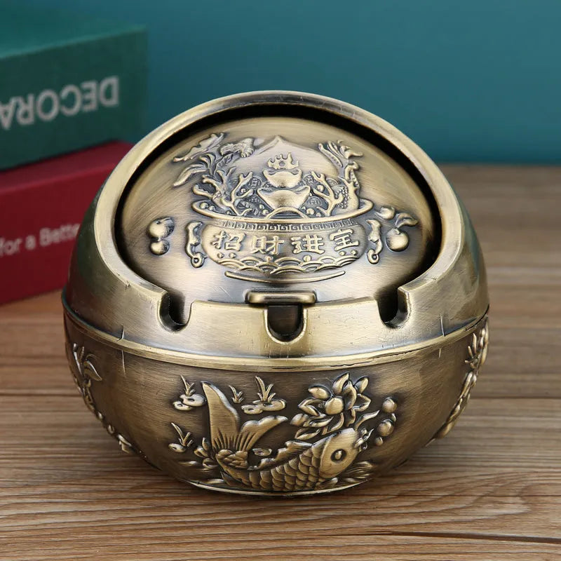 Alloy decorative ashtray with smoke extinguishing slot in bronze finish with symbolic design