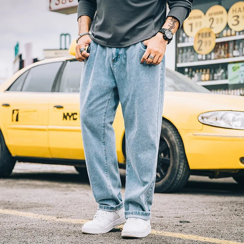 Men's loose straight-leg casual jeans in dark blue cotton on a hanger.