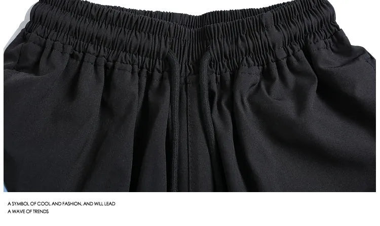 Men's quick-drying black sports shorts with loose straight-leg design and elastic waist for training