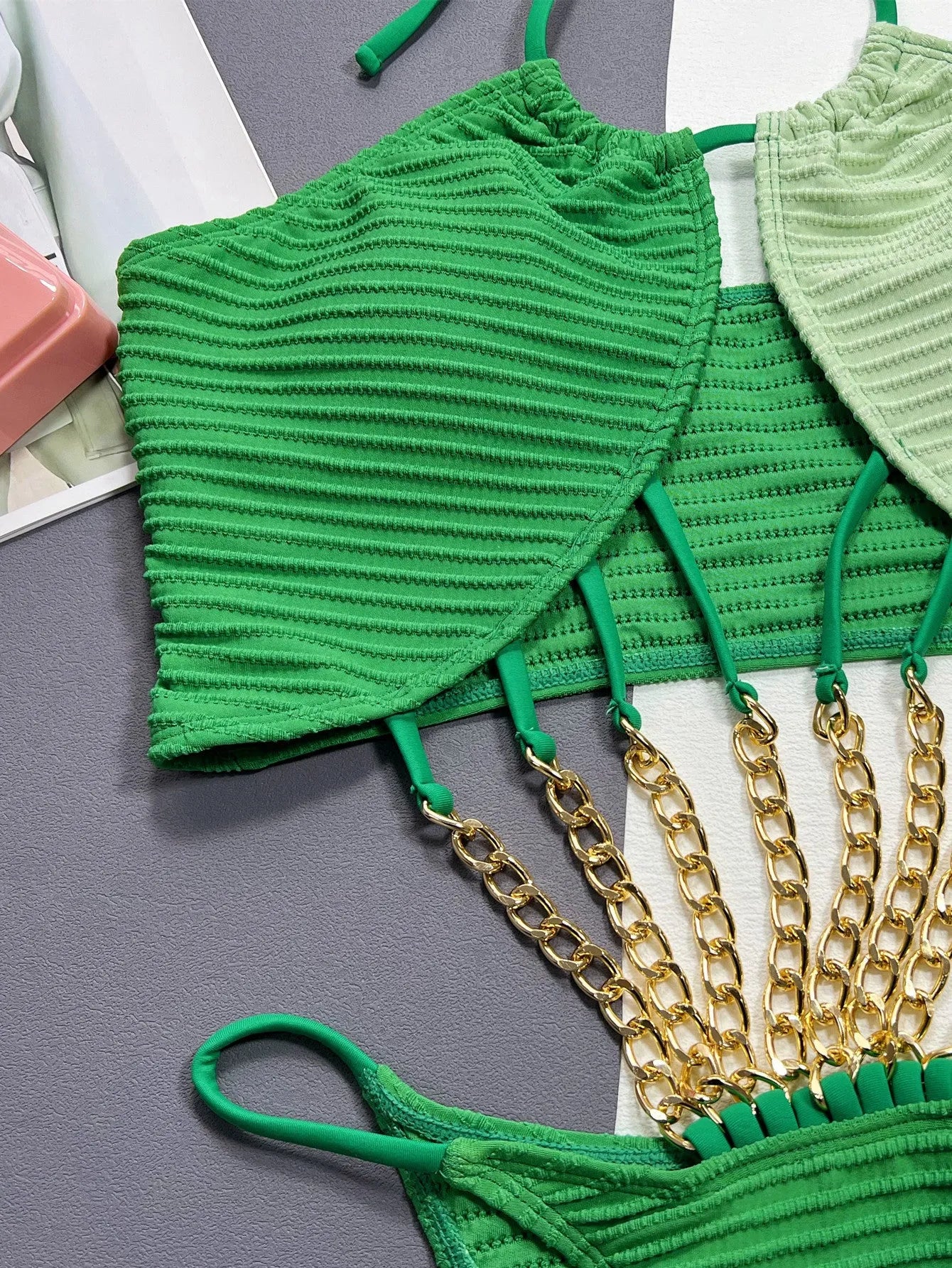 Green women's one-piece swimsuit with hollow design on mannequin