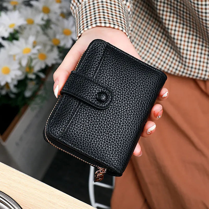 Women's beige lychee pattern short wallet made of PU, showing sewing thread detail and open organiser compartments.