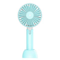 Blue handheld mini USB fan with three speed settings on a desktop