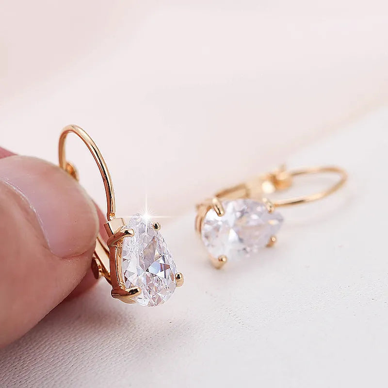 Women's drop-shaped copper earrings with gold finish and decorative platinum inlay.
