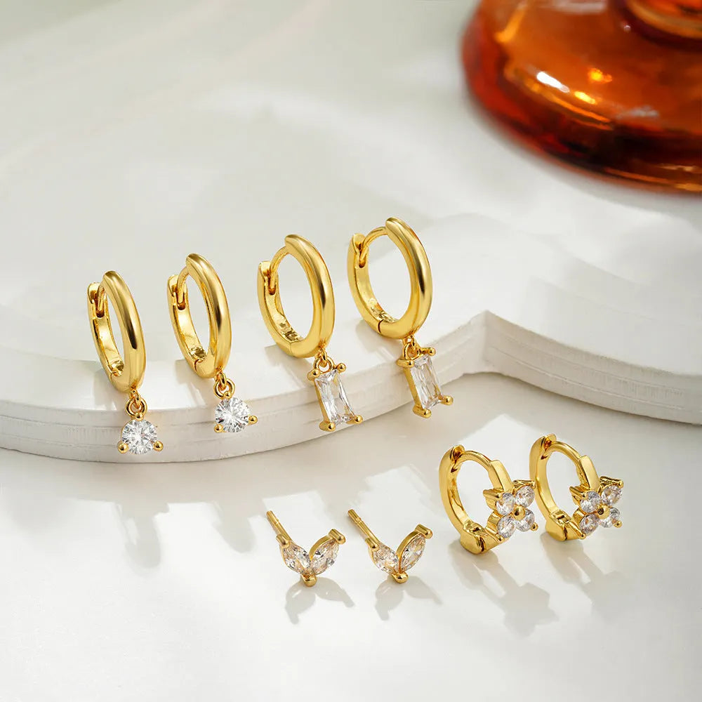 Four pairs of geometric copper earrings with zircon detailing in gold or silver electroplated finish