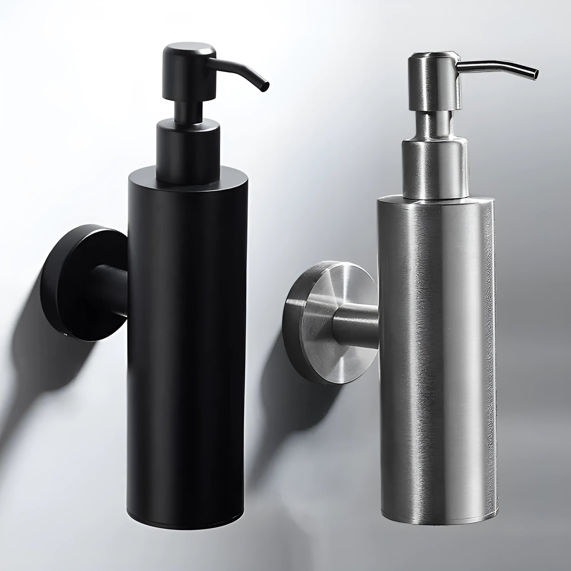 Stainless steel wall-mounted manual soap dispenser with a brushed metal finish.