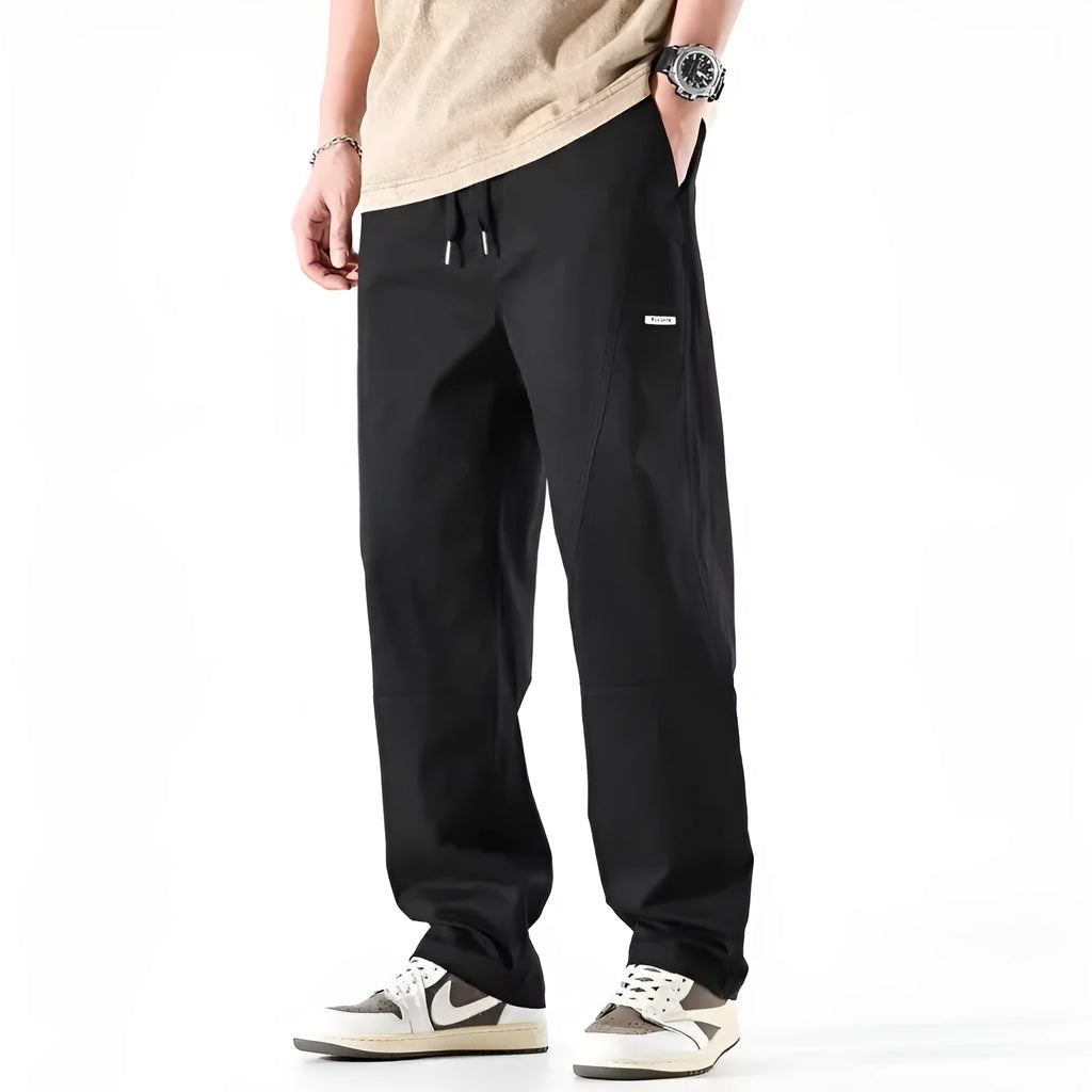 Women's milky white cotton wide-leg trousers with an elasticated waistband on a hanger.