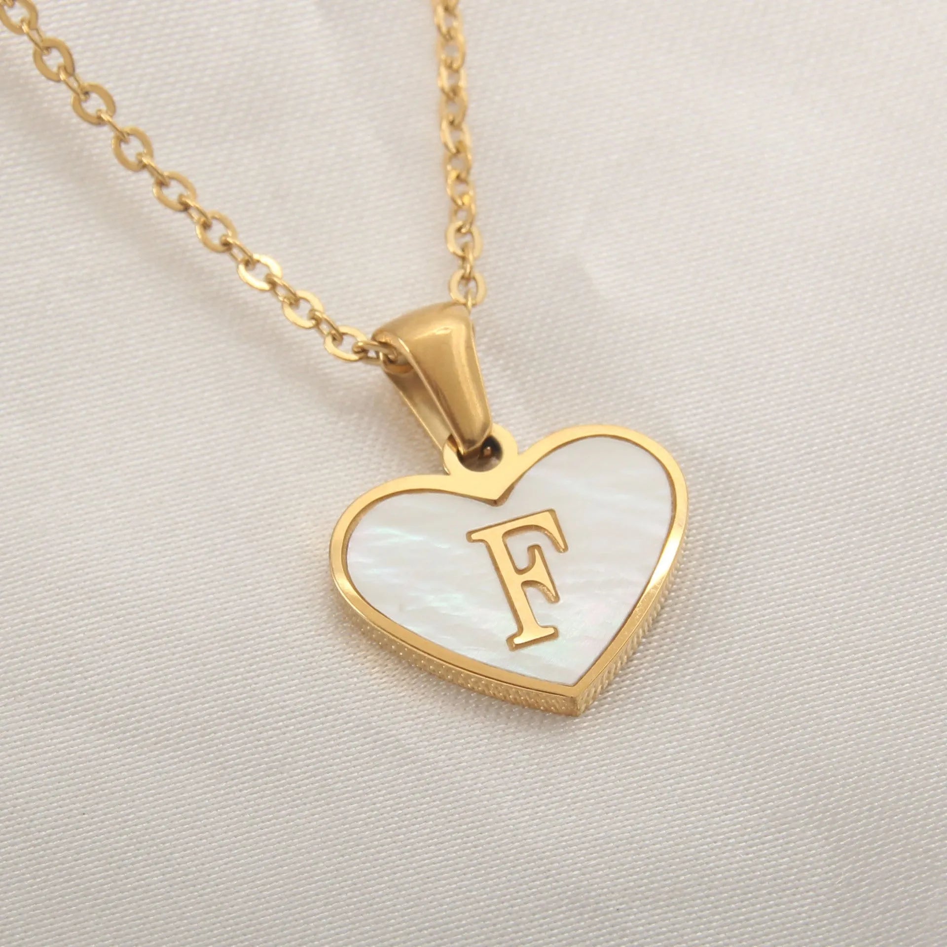 Gold plated heart necklace with white shell detail on an adjustable chain