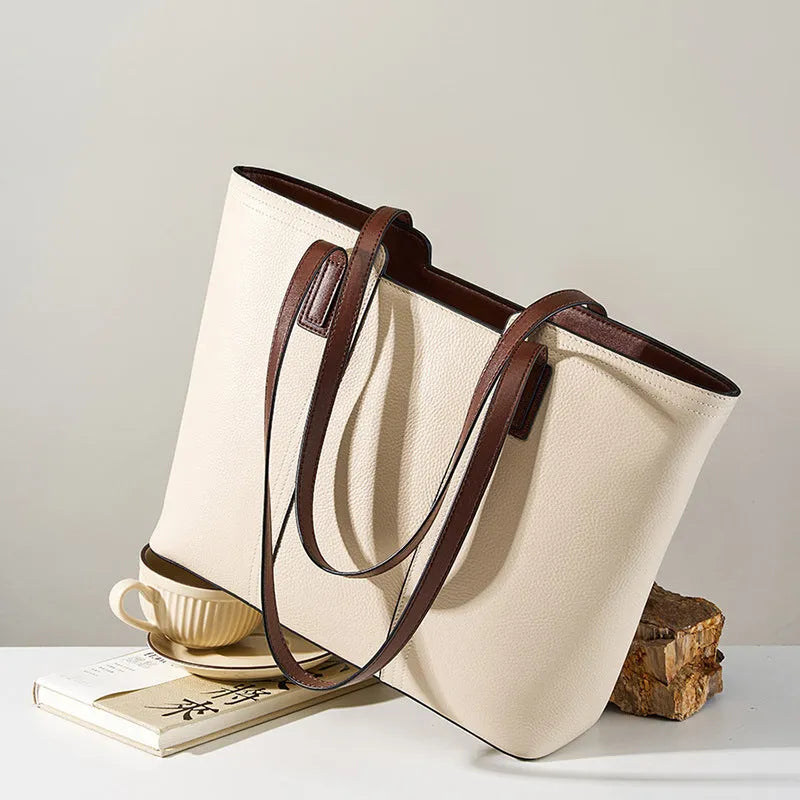 Black genuine leather women's shoulder bag showing internal organiser pockets and crossbody strap