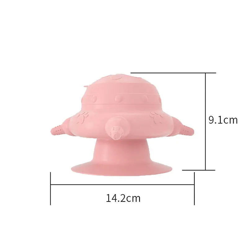 Pink silicone pet milk feeder with four nursing nipples for puppies and kittens on a flat base.