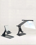 Black mobile phone screen amplifier with detachable phone holder on desktop surface