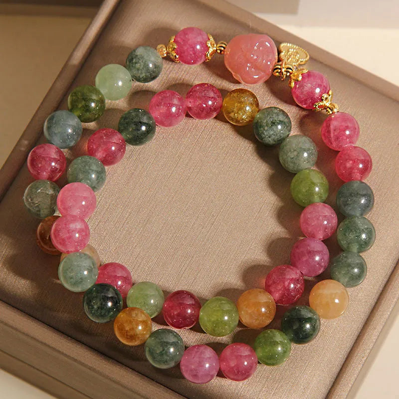 Natural jade colour tourmaline crystal double ring bracelet for women with Buddha head charm on white background