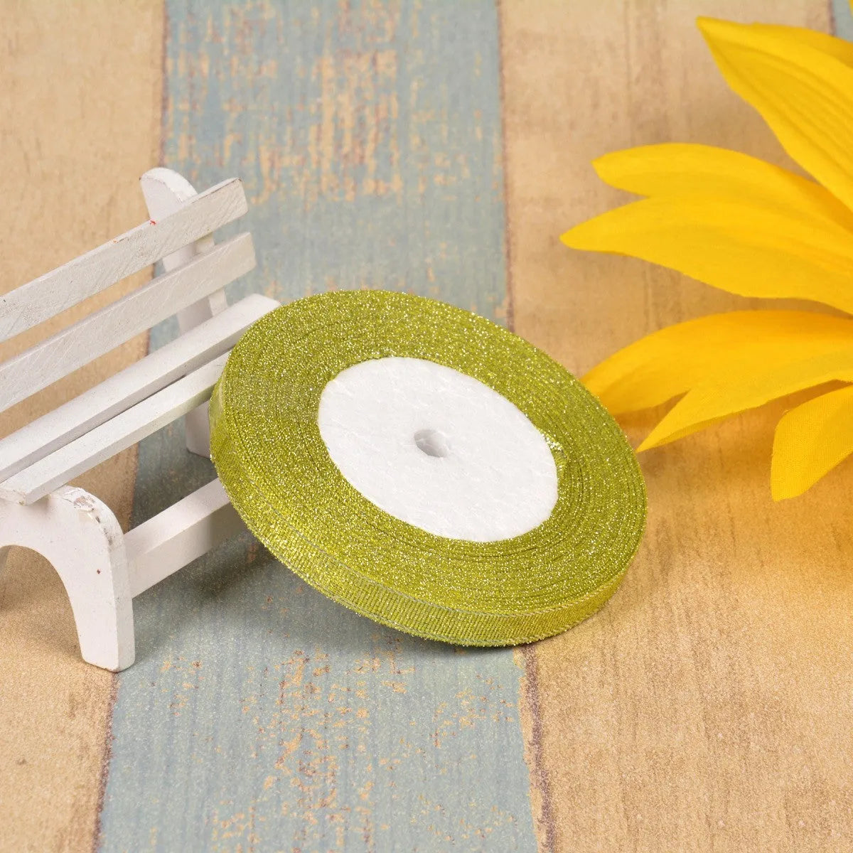 Green onion coloured polyester ribbon with gold polka dots on 25-yard spool for decorative trimming