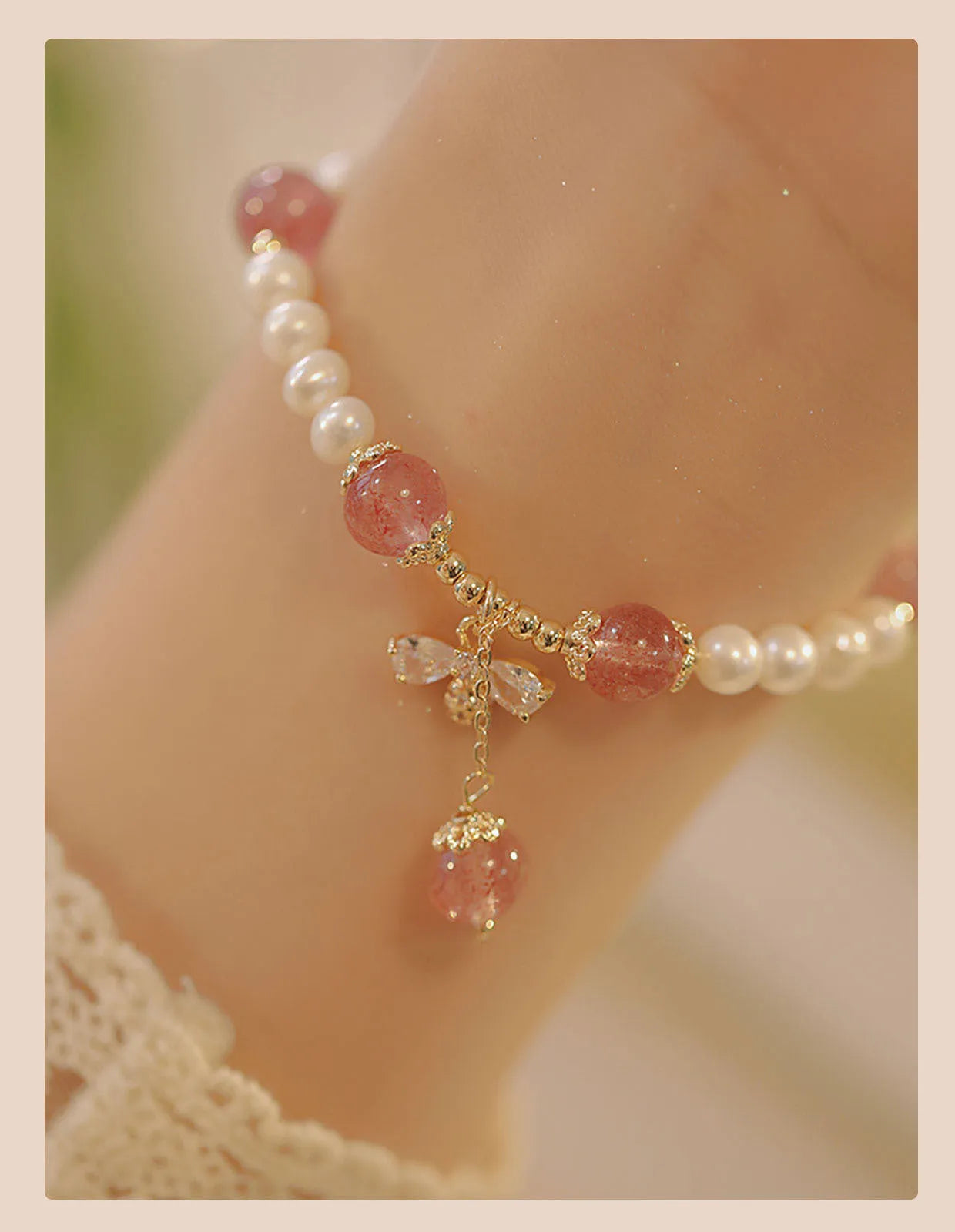 INS style women's crystal bracelet with strawberry quartz stones and a central bow detail.