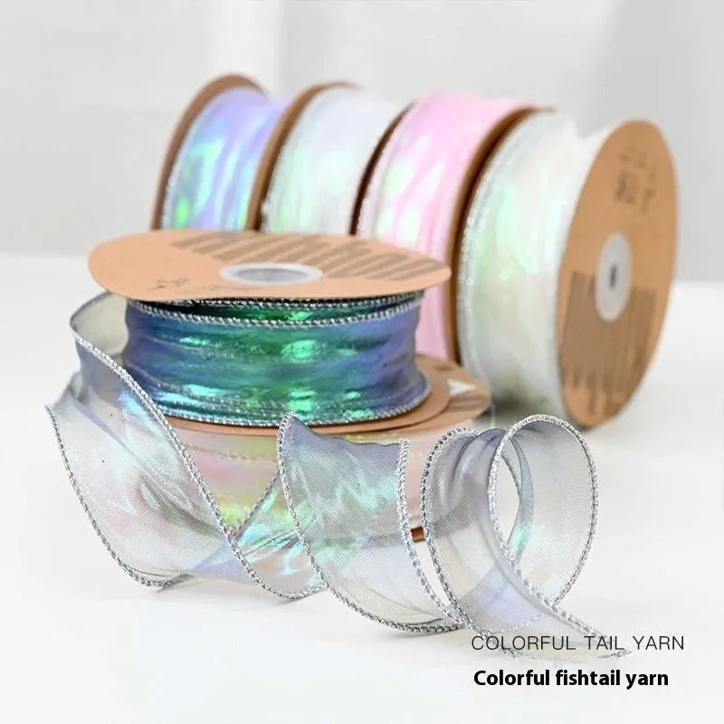 Roll of colourful fishtail yarn mesh ribbon with wave pattern, showing 4cm width.