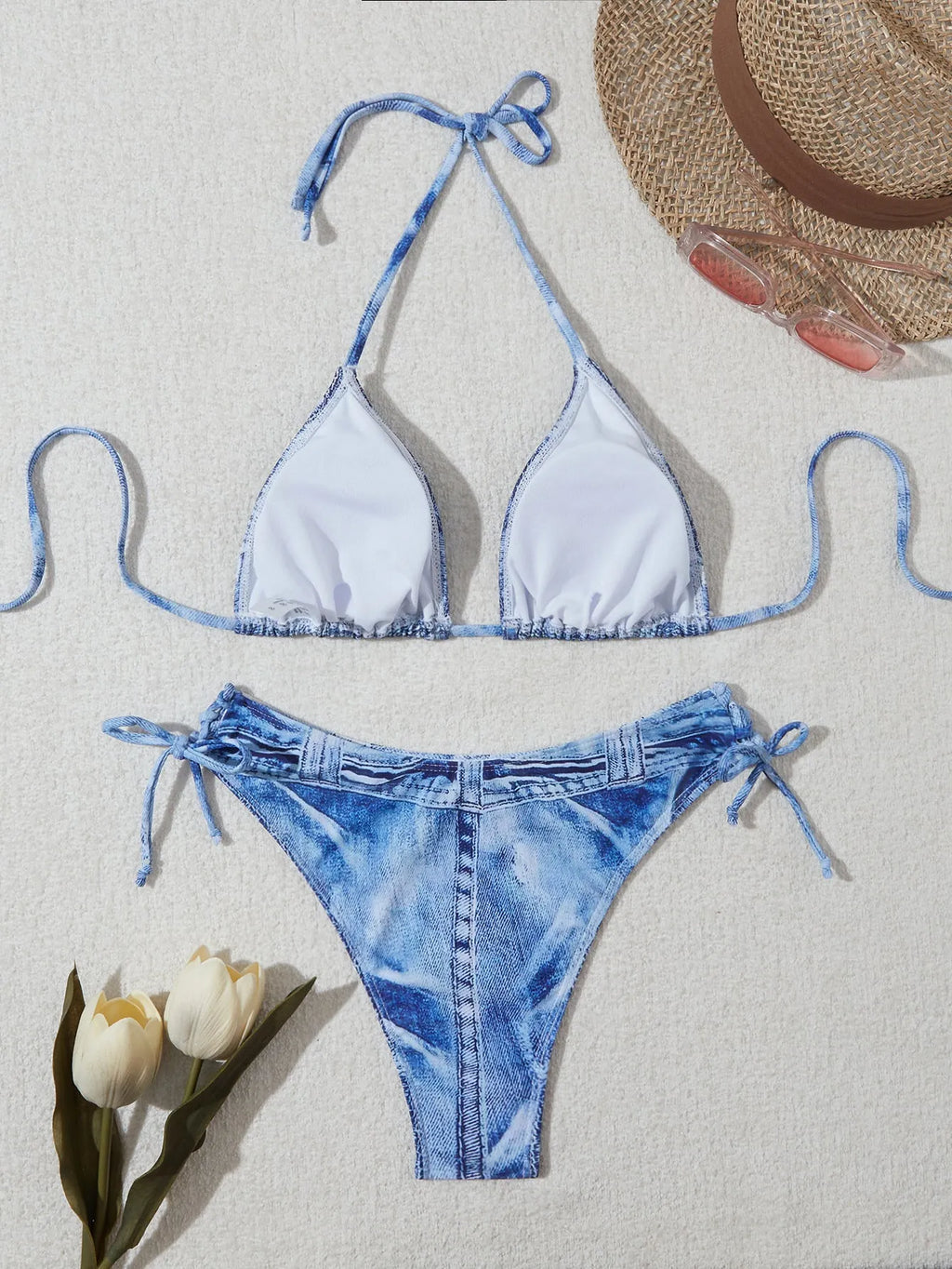 Women's denim blue printed bikini set with halterneck top and side-tie bottoms on a mannequin.