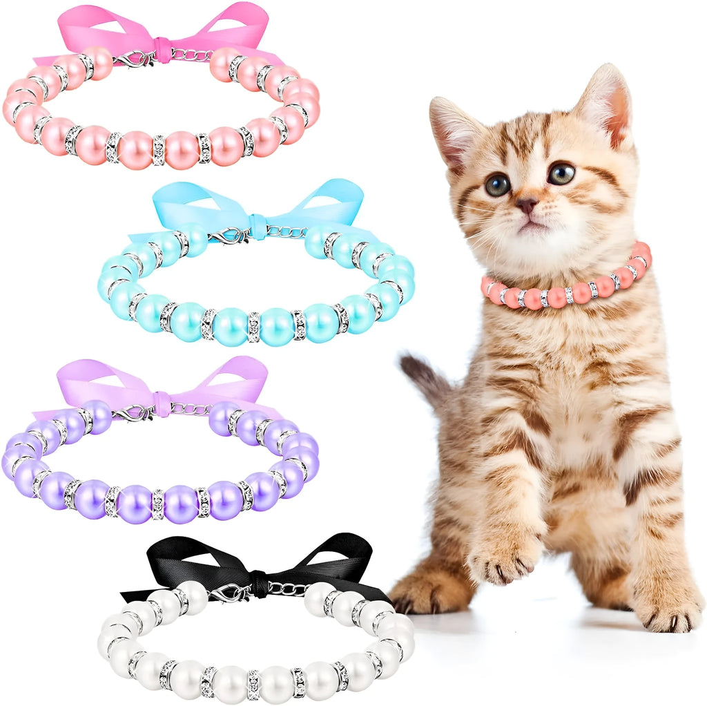 Small dog wearing blue pearl and rhinestone necklace with ribbon bow, adjustable clasp visible.