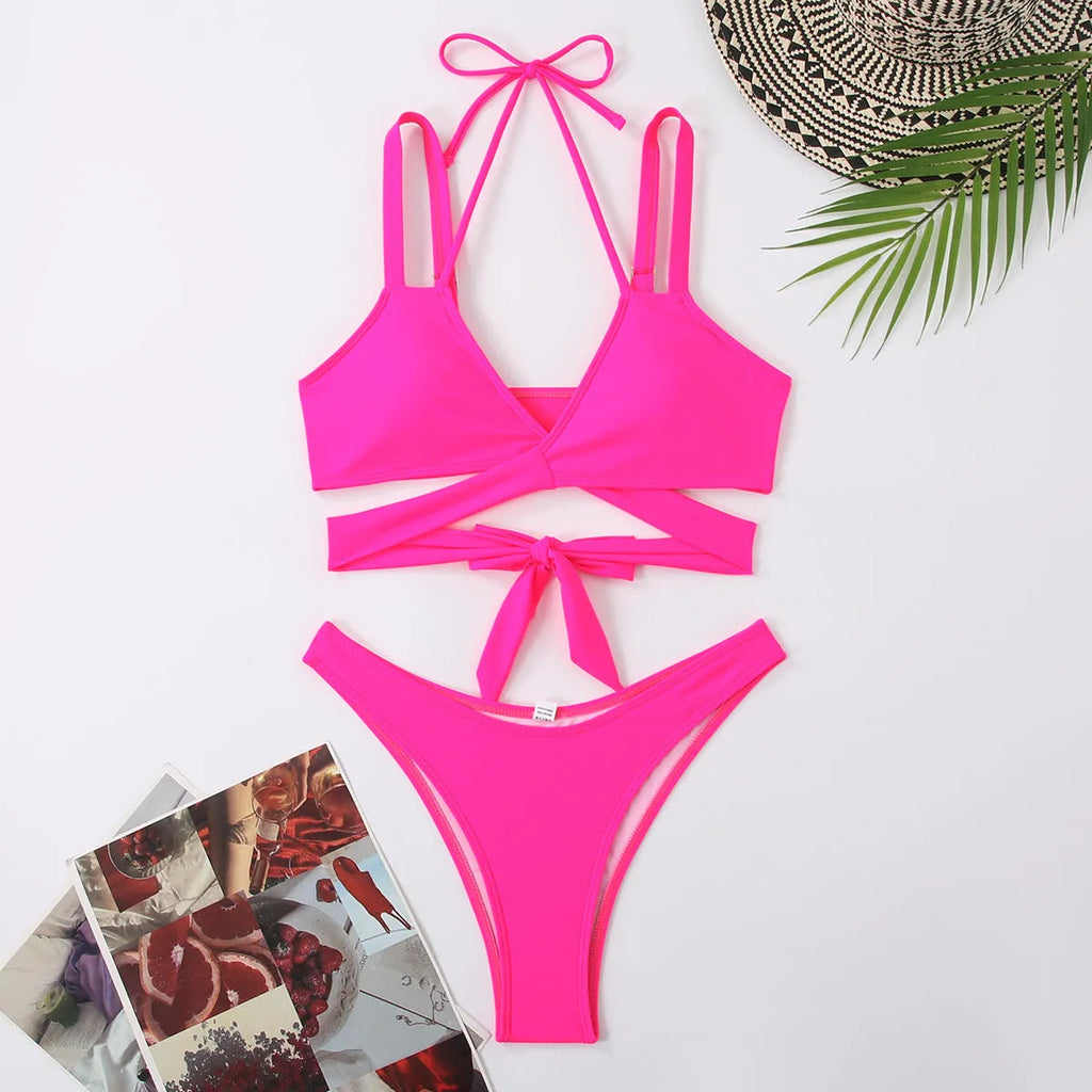 Solid colour women's strap bikini swimsuit on a hanger, shown in one of five colour options.