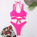 Solid colour women's strap bikini swimsuit on a hanger, shown in one of five colour options.