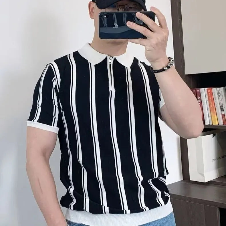 Man wearing a black vintage stripe t-shirt with a cartoon print and a zip detail on the half sleeve.
