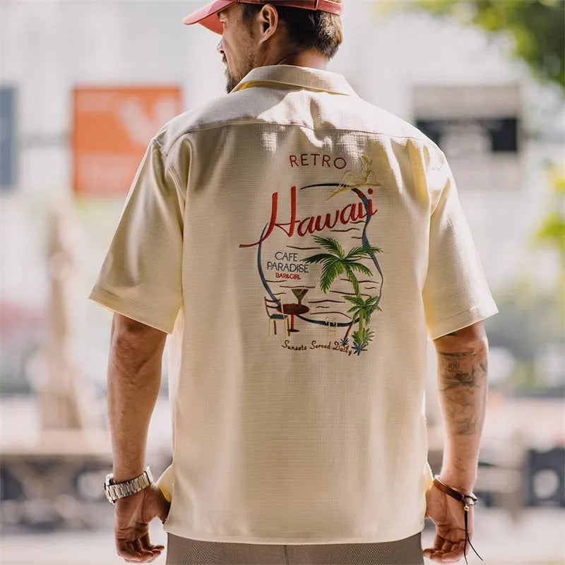 Light apricot men's Cuban collar shirt with an all-over bamboo and floral plant pattern print.
