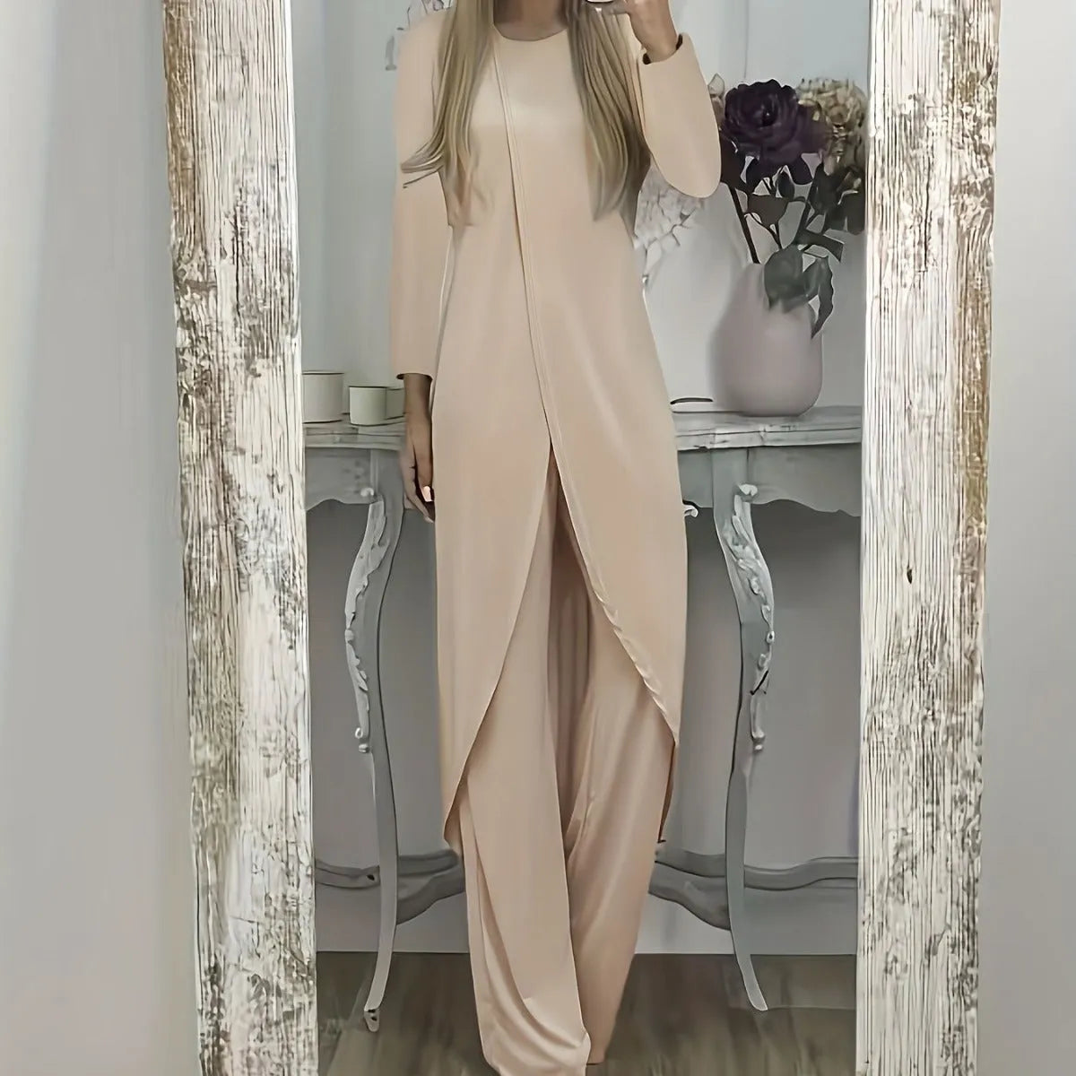 Casual long sleeve top and trousers lounge set in black, shown on a hanger