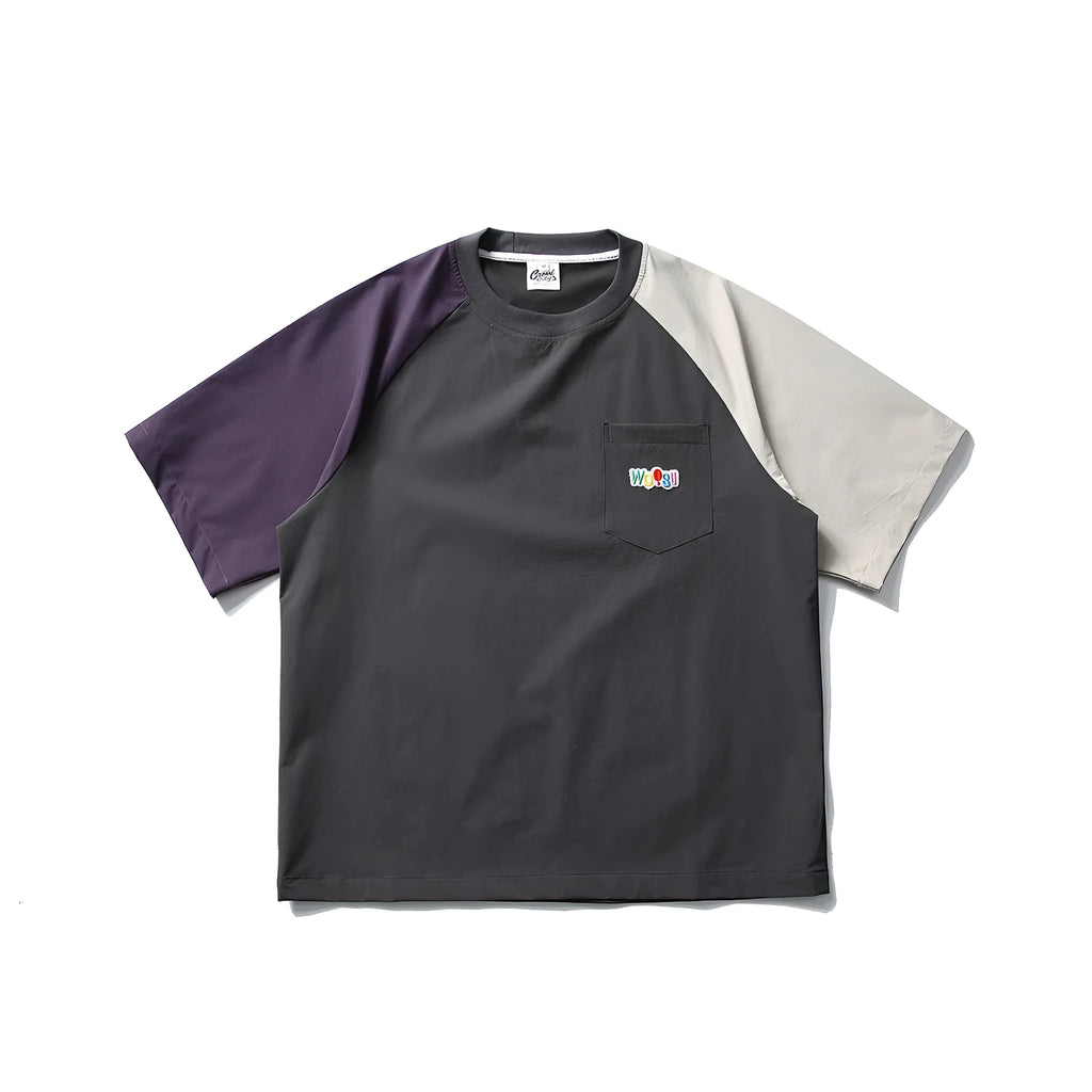 Dark grey men's loose fit t-shirt with contrasting colour raglan sleeves on a hanger.