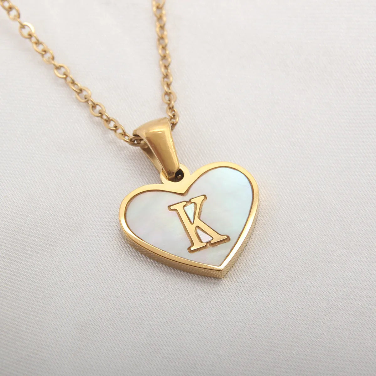 Gold plated heart necklace with white shell detail on an adjustable chain