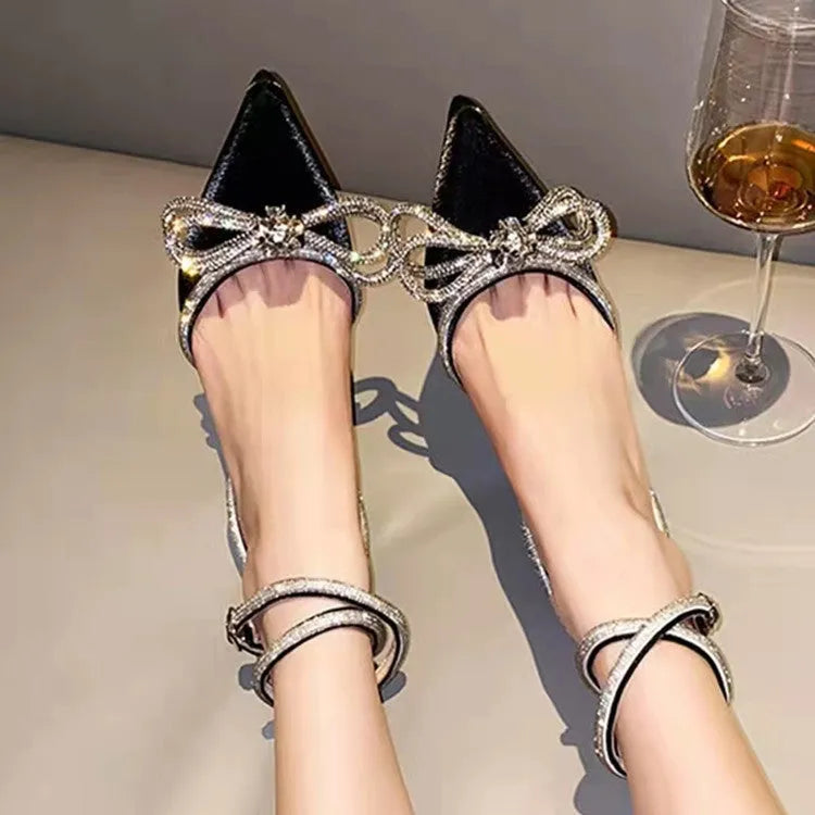 Women's black stiletto heel sandals with a silk bandage back strap and buckle closure.