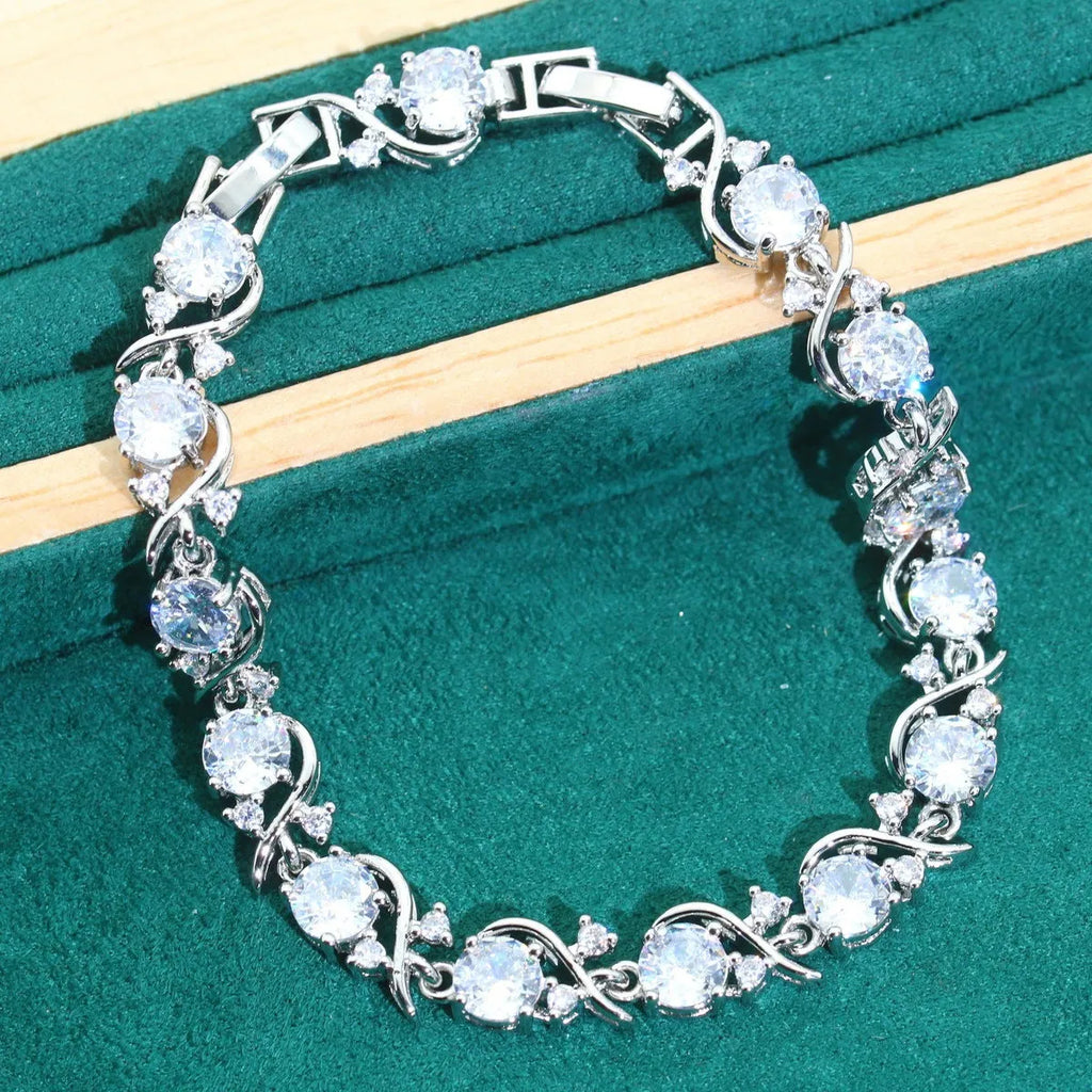 Bridal jewellery set with zircon accents showing necklace, earrings, ring, and bracelet in alloy construction