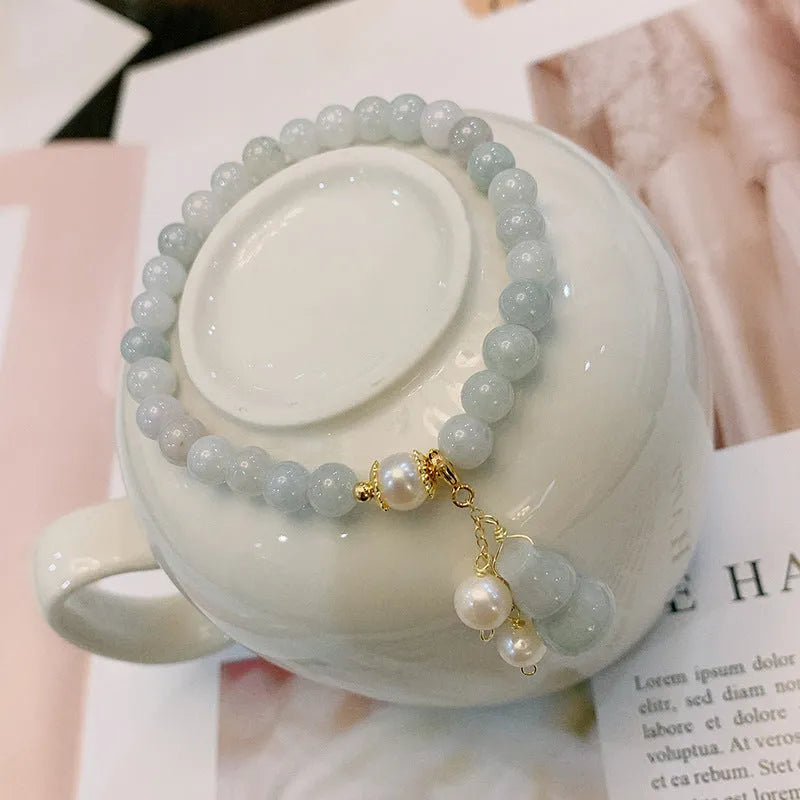 Chinese style jade bracelet with gourd design featuring natural emerald stone and pearl accents