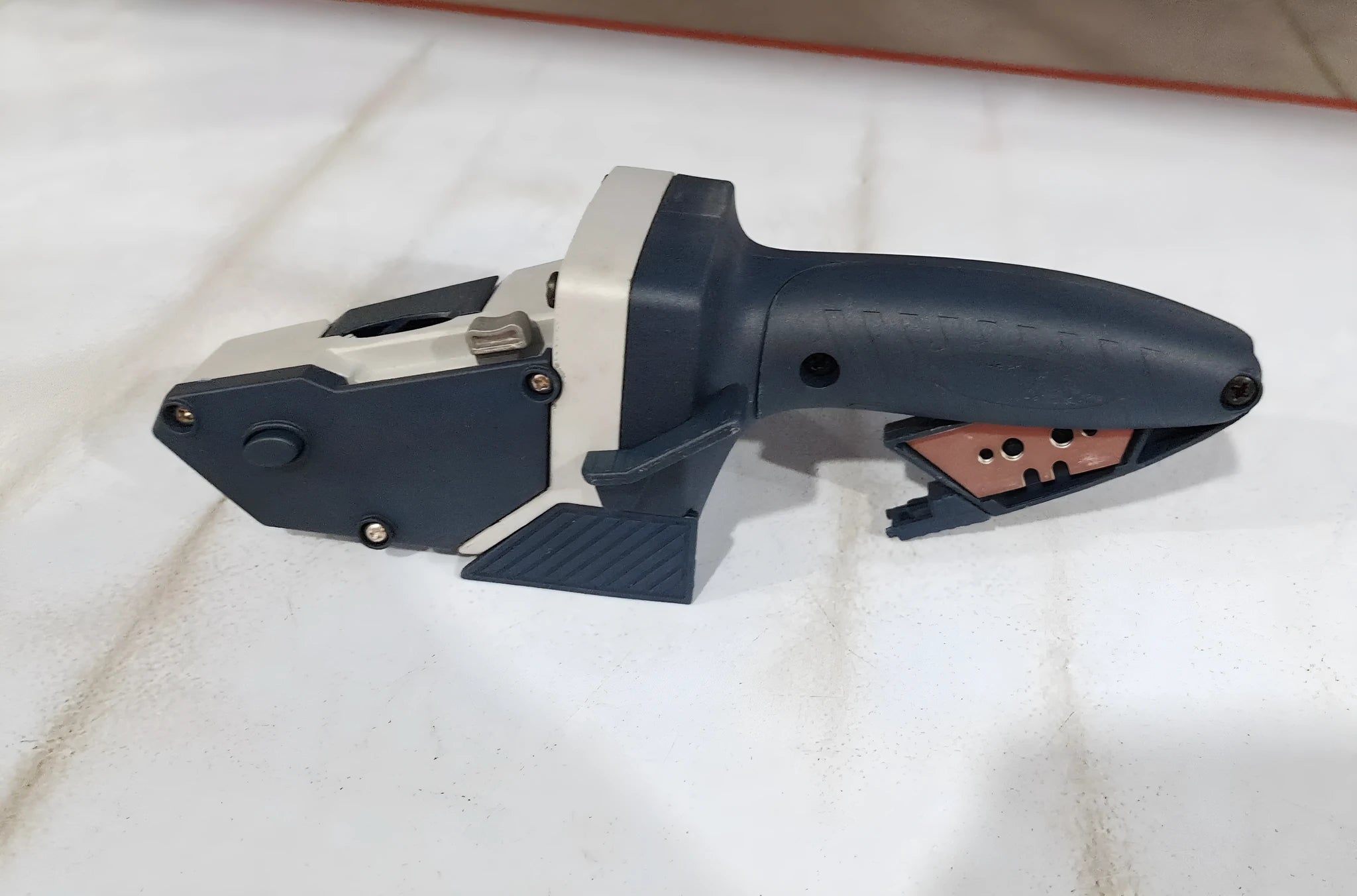 Blue aluminium and TPR plastic multifunctional woodworking cutter with measuring scale.