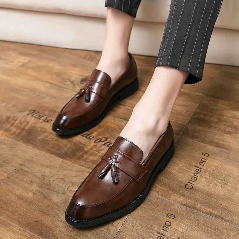 Men's black slip-on tassel loafers with low-top design and rubber sole for business casual wear