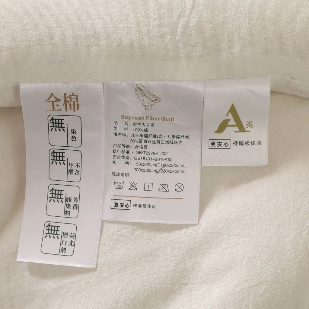 Soybean fibre pure cotton quilt shown in grey, pink jade or white colour on a bed.