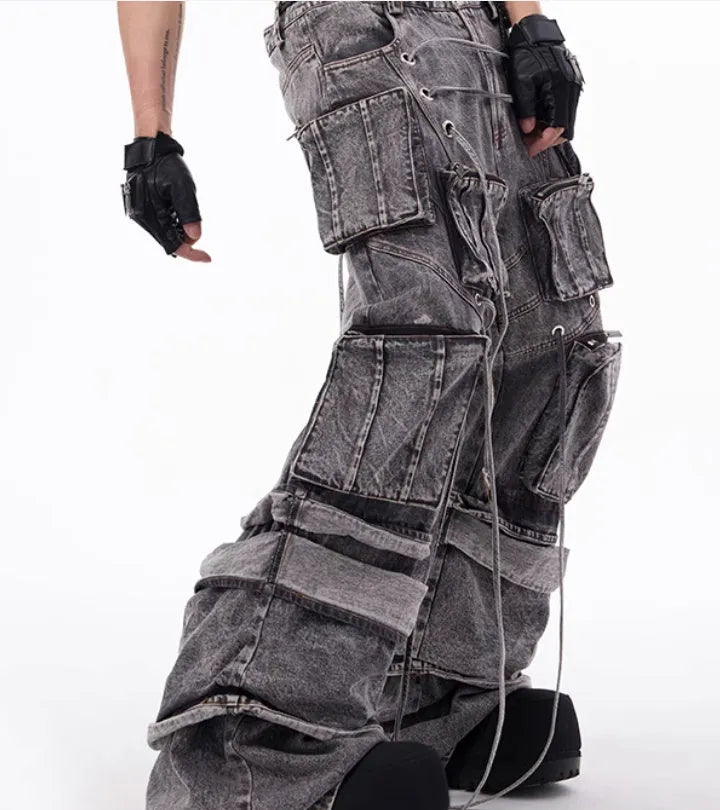 Grey denim distressed overalls with rope stitching and a wide-leg mop pants silhouette.