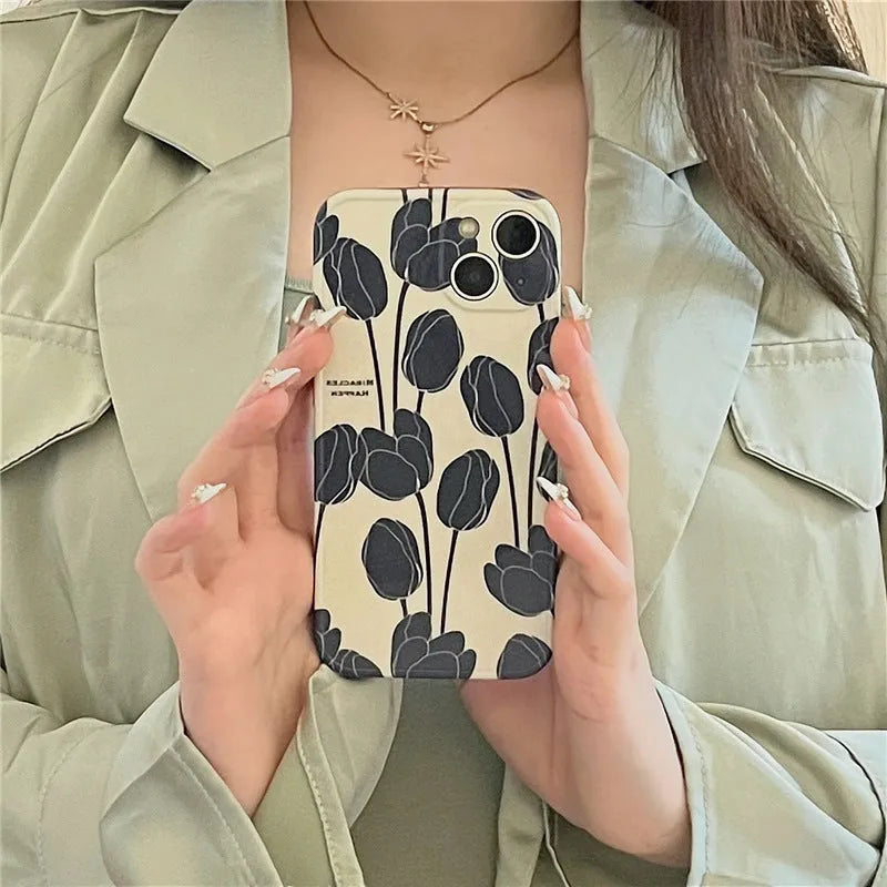 Black silicone iPhone case with intricate cold wind tulip pattern design on back cover