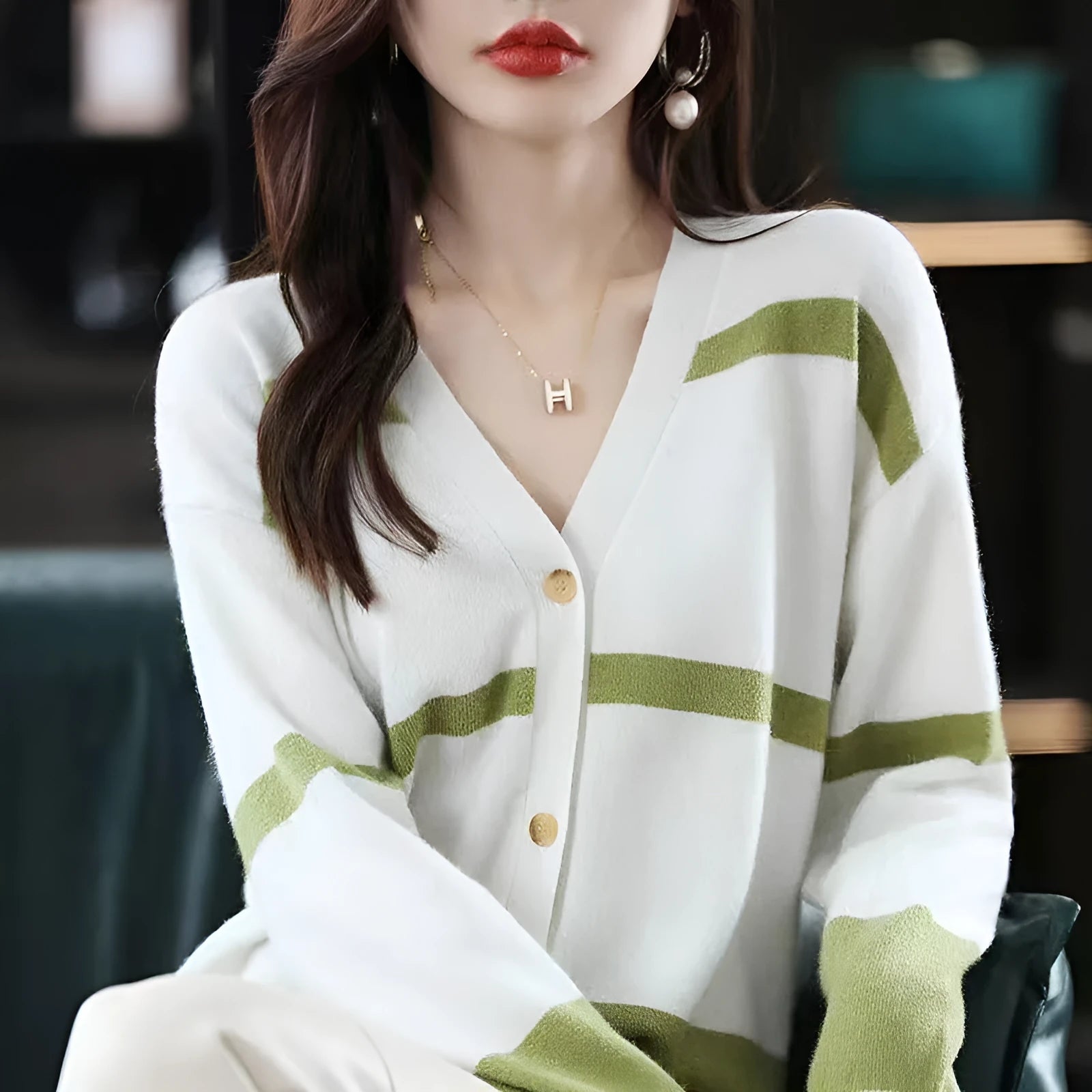 Women's striped V-neck knit cardigan buttoned up, shown in a slim fit.