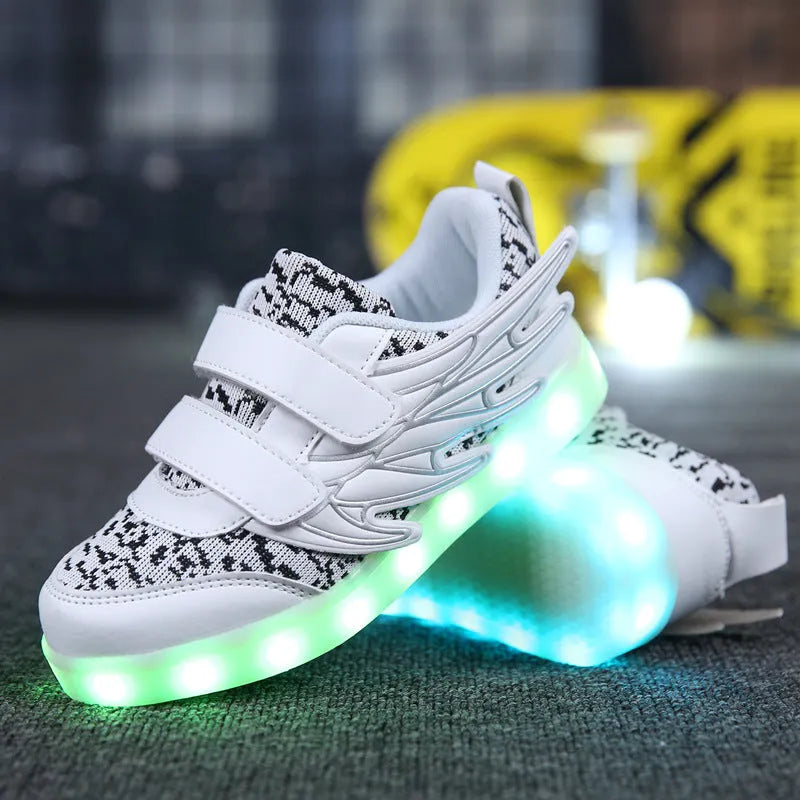 Children's plum red and white LED light-up sneakers showing flashing soles and USB charging cable.