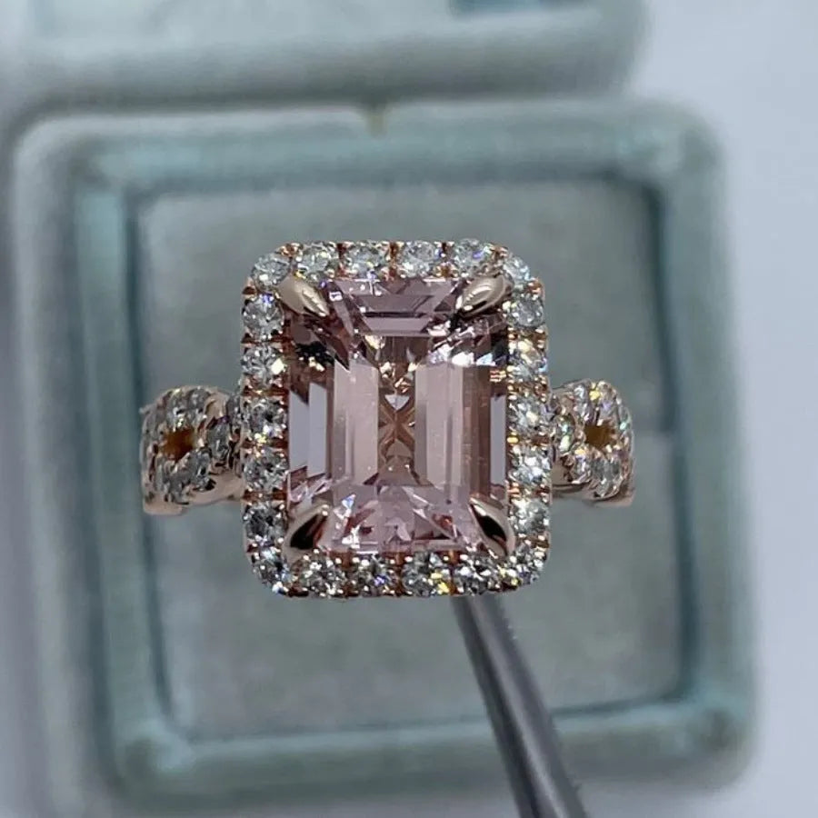 Geometric rose gold coloured alloy ring for women and men on a grey background.