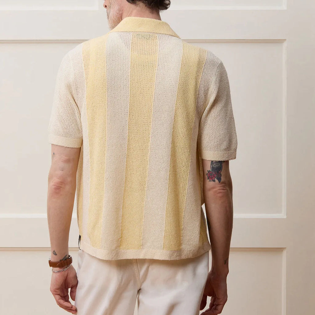 Yellow asymmetric hollow-out short sleeve polo shirt made from Tencel fabric on a model.